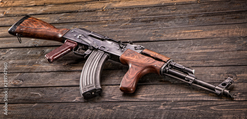 Romanian AK47 on wooden background. photo