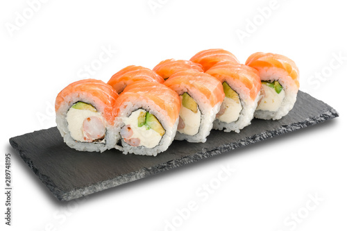 Sushi Rolls with salmon, avocado, crab sticks, nori leaf and Cream Cheese inside on black slate isolated on white