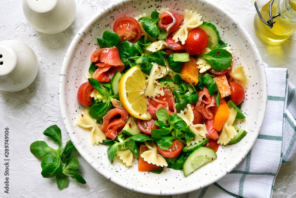 Pasta salad with vegetables and salted salmon. Top view with copy space. Pasta salad with vegetables and salted salmon. Top view with copy space.