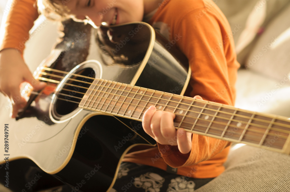 Fototapeta premium child with black acoustic guitar