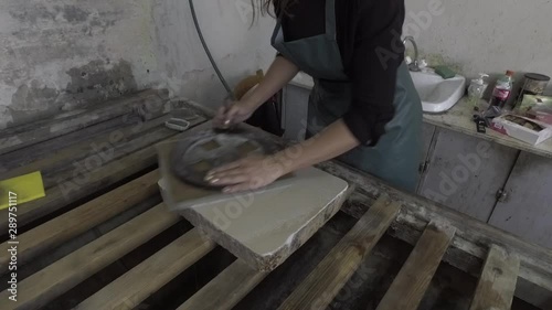 Woman artist polishing lithographic stone
