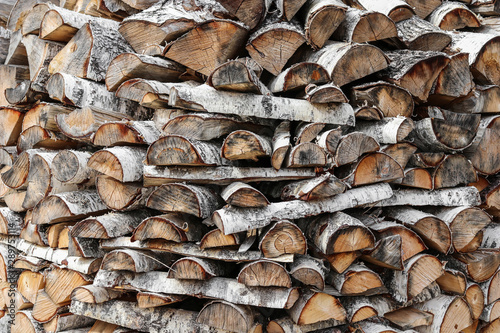 Sawn logs of birch forestry. Woodpile, firewood.