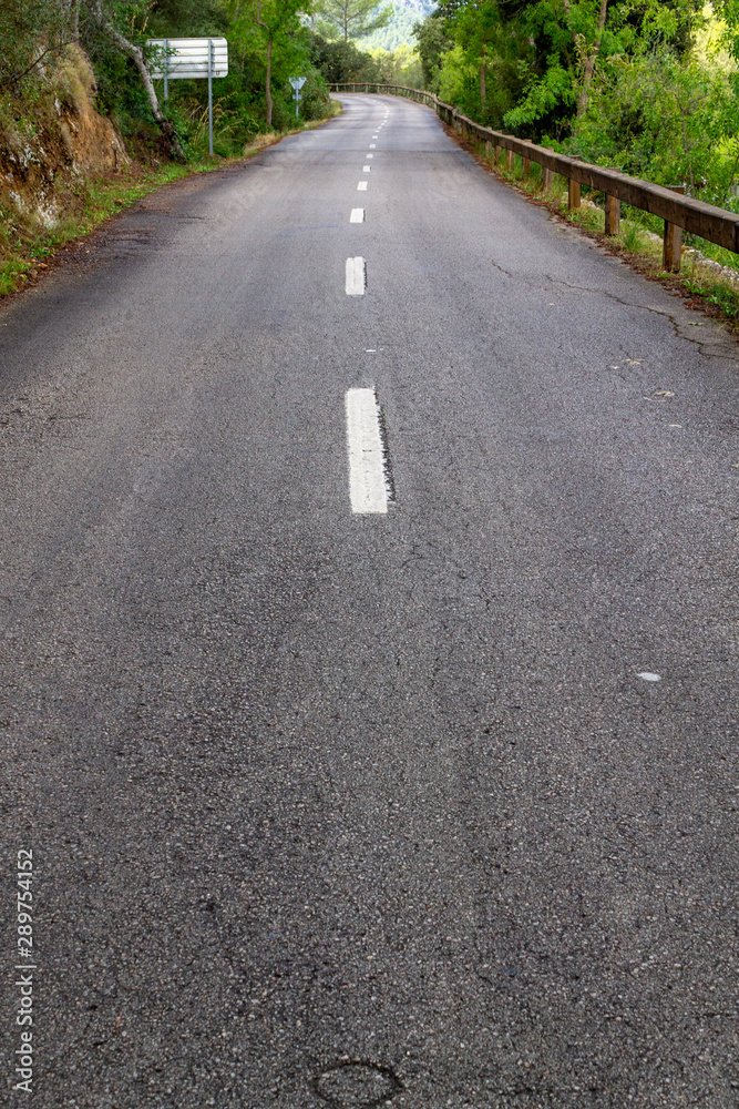 black asphalt road and white dividing lines
