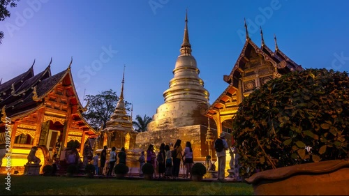 CHIANG MAI, THAILAND - NOVEMBER 20, 2018 : Unidentified tourists are traveling to Wat Phra Singh or Phra Singh temple in the twilight ,located in the old city centre of Chiang Mai Province ,Thailand,