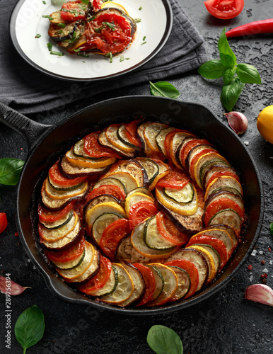 Ratatouille Vegetable Stew with zucchini, eggplants, tomatoes, garlic, onion and basil. on cast iron pan. Traditional French food. photo