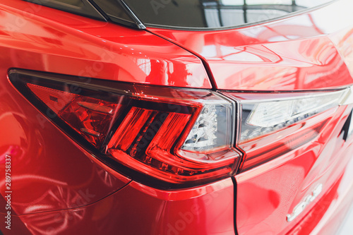 Fotografie Detail on the rear light of a red car.