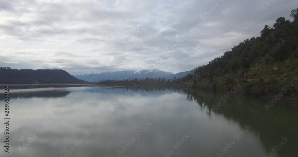 New Zealand West Coast Landscape. Aerial of Pristine Nature and Lake Under Southern Alps and Cloudy Autumn Skyline
