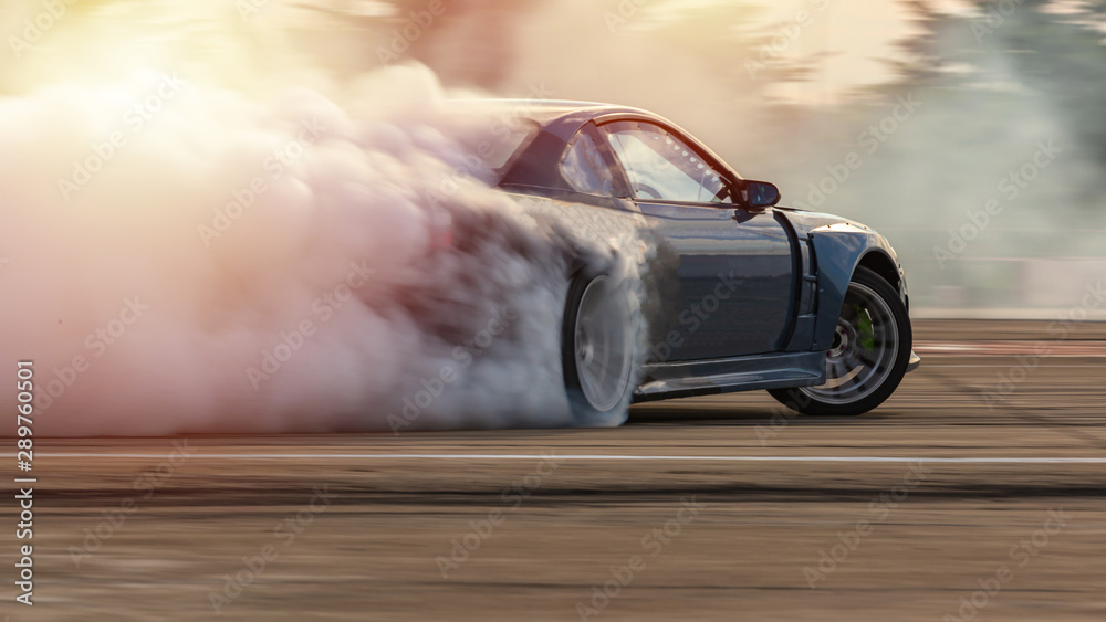 Car drifting, Blurred image diffusion race drift car with lots of smoke from burning tires on speed track.
