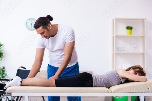 Young woman visiting male doctor physiotherapist