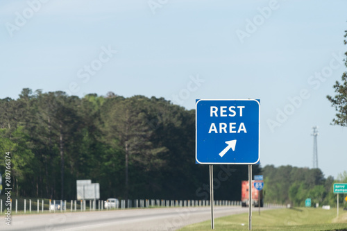 Highway road in Alabama with welcome center rest area sign on street with nobody at visitor center in Lanett, Alabama