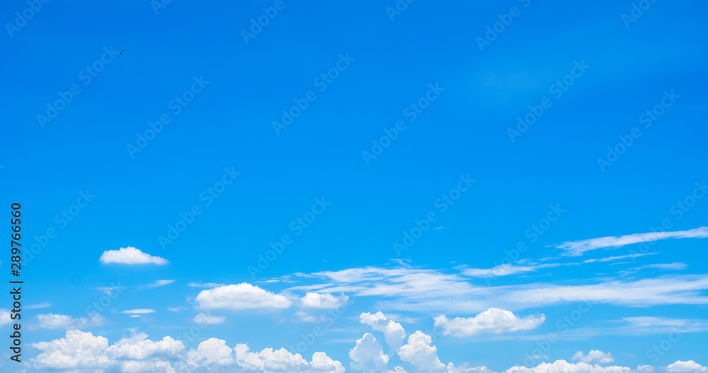 Beautiful blue sky and white cumulus clouds abstract background. Cloudscape background. Blue sky and fluffy white clouds on sunny day. Nature weather. Bright day sky for happy day background. - obrazy, fototapety, plakaty 