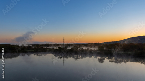 Water evapoation on the river at dawn with beautiful reflection