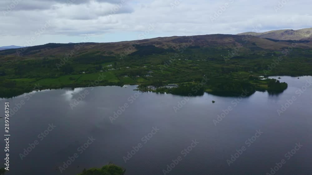 Aerial of lake hotel in Lough Eske surrounded by greenery and nature Aerial of lake hotel in Lough Eske surrounded by greenery and nature