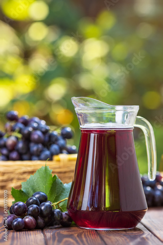 Canvas Print grape juice in glass jug