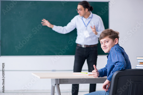 Young male teacher and boy in the classroom © Elnur