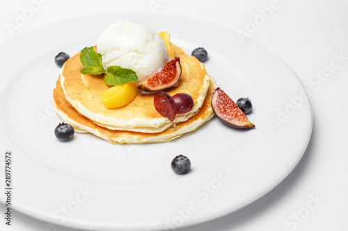 pancakes with ice cream and a berries