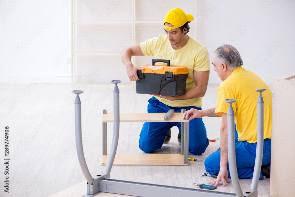Two contractors carpenters working indoors