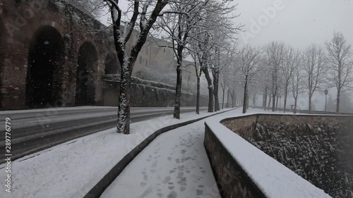 Bergamo, Italy. The Old town. Hyperlapse pedestrian POV point of view walking along the Venetian walls during a snowfall. Winter time photo