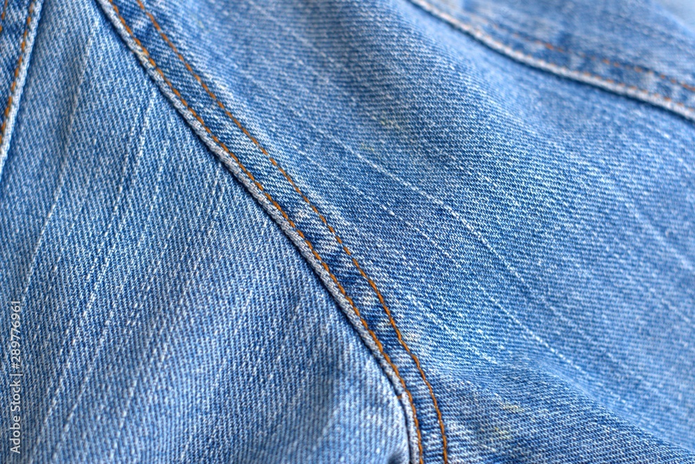 Blue worn denim jeans texture detail close up. Blue worn denim jeans texture detail close up.