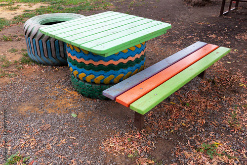 Homemade furniture set of old, used tires and wood on the Playground. photo