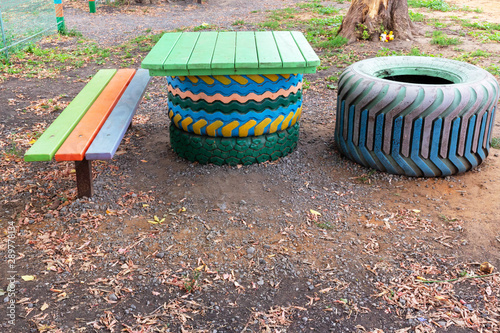 Homemade furniture set of old, used tires and wood on the Playground.