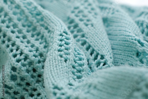 Aquamarine color crochet sweater. Texture detail close up.