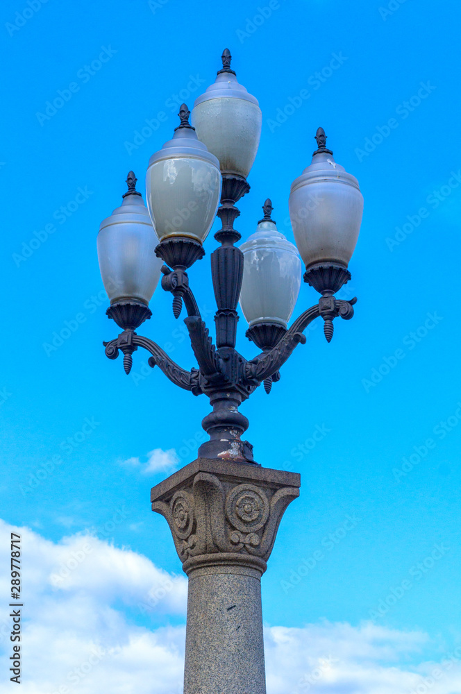 Street lamp against the blue sky on a summer day.