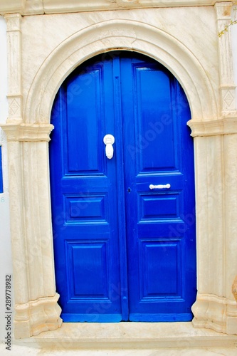 Traditional wooden door in blue color, in Tinos island, Cyclades, Greece. photo