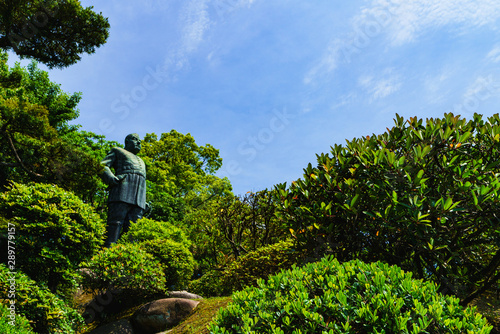 Landscape of bronze statue of Kagoshima hero in the background of blue sky and Shiroyama in summer Japan ( captured on the public road ) 