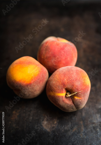 Sweet ripe peaches on the rustic background. Selective focus. Shallow depth of field.