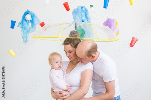 Environmental pollution, plastic recycling problem and ecology problem concept - sad family under garbage on white background. © satura_