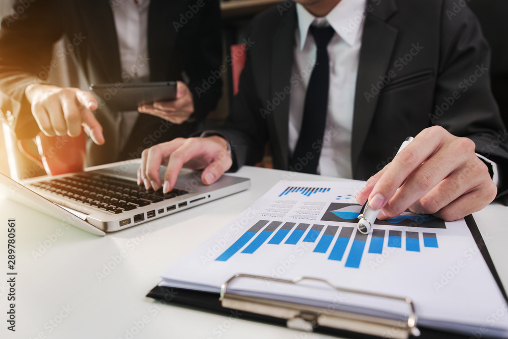 Businessman working as a team start meeting the new marketing project plan By business people using tablets and graph documents Calculate the amount of money for the project. Businessman working as a team start meeting the new marketing project plan By business people using tablets and graph documents Calculate the amount of money for the project.