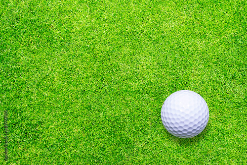 Golf ball on green texture background