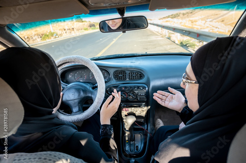 Two arabic women driving while arguing