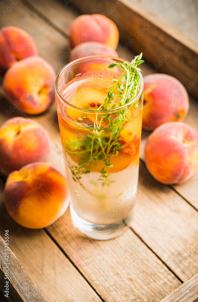 Gin based cocktail with peaches and thyme. Selective focus. Shallow depth of field. Gin based cocktail with peaches and thyme. Selective focus. Shallow depth of field.