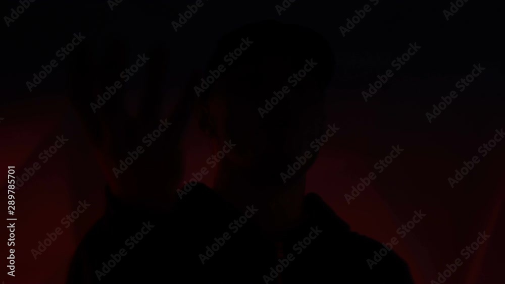 Rapper guy rap in front of the camera on a colorful background Rapper guy rap in front of the camera on a colorful background