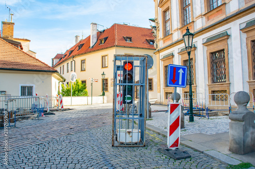 CZ, Prague 09.08.2019: Traffic light locked in a steel cage on the street of an old European city