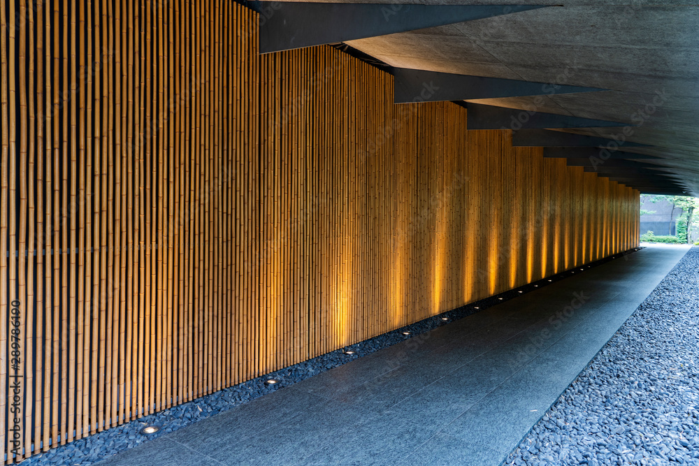 Obraz premium Bottom Lighting of Bamboo Wall Along the Corridor.