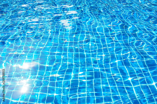 Top view of beautiful swimming pool with clear water and sunlight reflection on the surface in blue and turquoise color in the morning Relaxation on a day off, blurred focus of water motion background © TS.PHOTOS