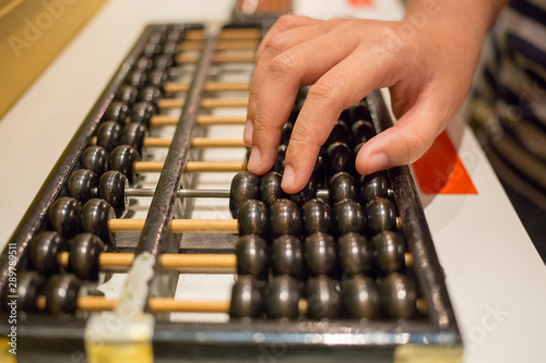 Hands on the black abacus, focus selective