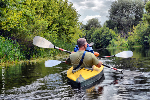 Ukraine, Psyol, 26,07,2019. Couple kayaking together in mangrove river.  Tourists kayakers touring the river of Islamorada. Ukraine, Psyol, 26,07,2019.