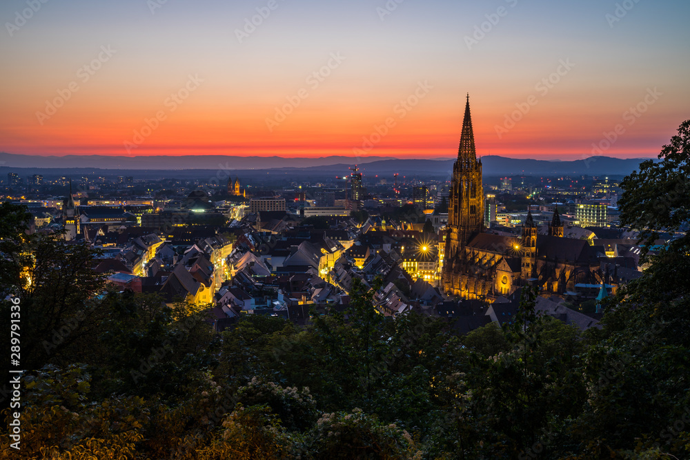 Germany, Extreme red sky over city freiburg im breisgau in black forest nature landscape of baden famour for its muenster cathedral after sunset in summer