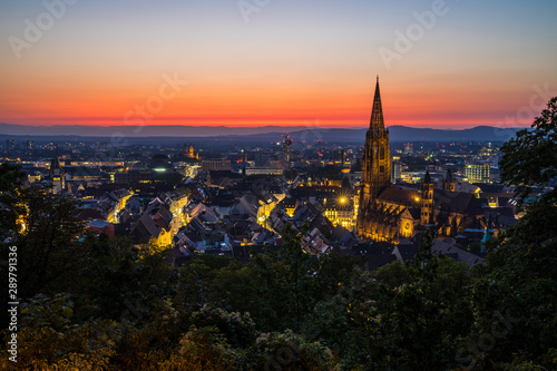 Germany, Extreme red sky over city freiburg im breisgau in black forest nature landscape of baden famour for its muenster cathedral after sunset in summer