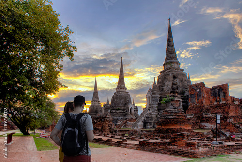 Man and women Traveller travel enjoying a looking at sunset at Temple Ayutthaya in Wat Phar sri sanphet.