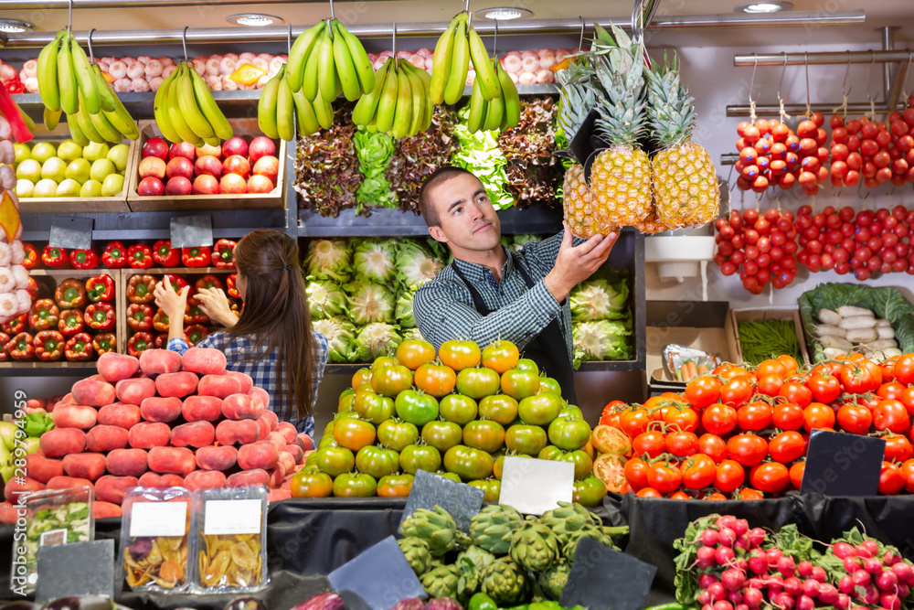 Shop assistants working in fruit and vegetable shop