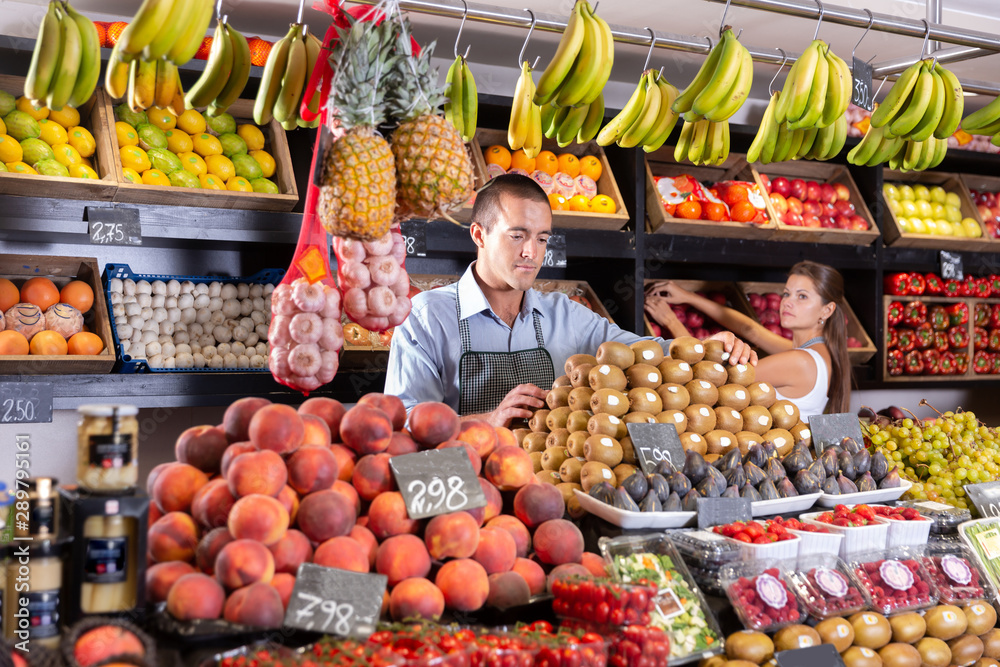 Glad female and man laying out vegetables