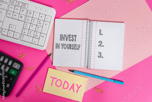 Writing note showing Invest In Yourself. Business concept for learn new things or materials thus making your lot better Writing equipments and computer stuffs placed above colored plain table