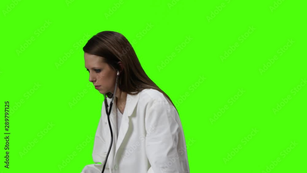 Young Brown Blonde Woman With White Doctor Lab Coat Uses A Stethoscope And Hangs It Over Her Shoulders Young Brown Blonde Woman With White Doctor Lab Coat Uses A Stethoscope And Hangs It Over Her Shoulders