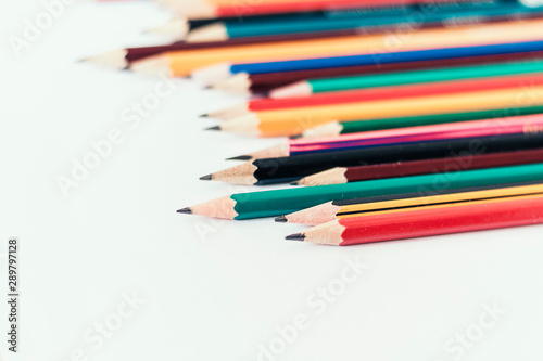 colored pencils on white table, back to school education concept background.