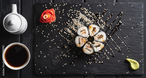 Sushi set nigiri and sushi rolls on black stone plate